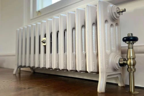 Cream cast-iron column radiator with antique brass valve